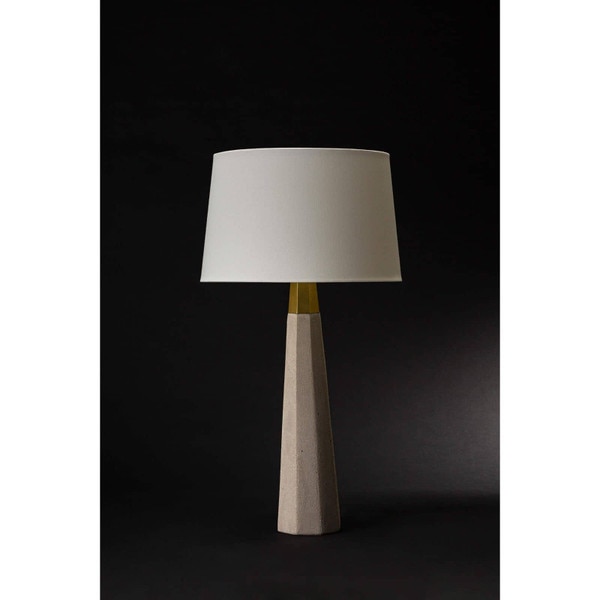 Concrete table lamp with a white shade on a black background